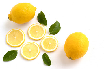 lemon with lime and leaves on white background