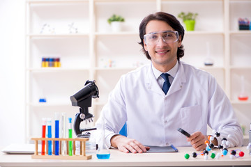 Young male scientist working in the lab 