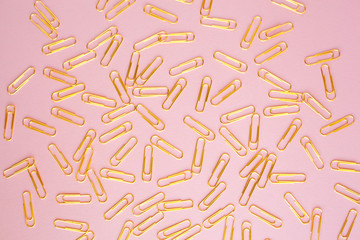 Gold paperclips, pink background