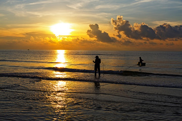 Sunrise morning and fisherman at the beach