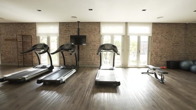 Point of view shot of treadmills in empty gym