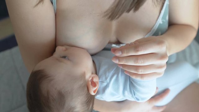 Breast feeding, breastfeeding concept. Happy Mother feeding her Newborn baby.