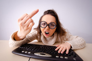 Funny nerd girl working on computer