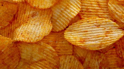 Texture fried golden brown potato chips, close-up
