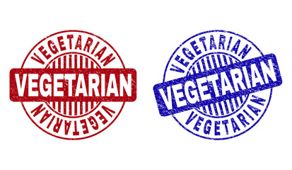 Grunge VEGETARIAN round stamp seals isolated on a white background. Round seals with grunge texture in red and blue colors. Vector rubber overlay of VEGETARIAN caption inside circle form with stripes.