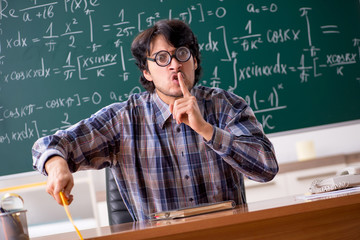 Funny male math teacher in the classroom 