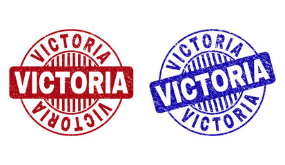 Grunge VICTORIA round stamp seals isolated on a white background. Round seals with grunge texture in red and blue colors. Vector rubber overlay of VICTORIA label inside circle form with stripes.