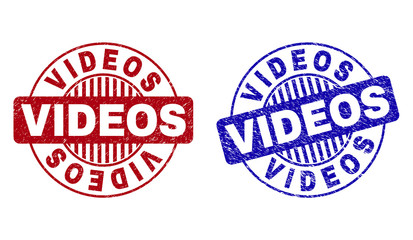 Grunge VIDEOS round stamp seals isolated on a white background. Round seals with grunge texture in red and blue colors. Vector rubber imitation of VIDEOS title inside circle form with stripes.