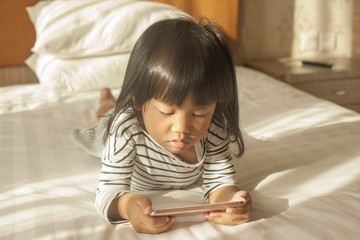 Little Girl Plays with Gadget Smart Phone