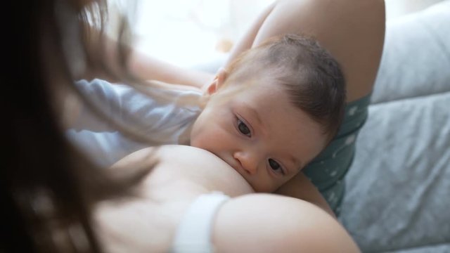 Breast feeding, breastfeeding concept. Happy Mother feeding her Newborn baby.