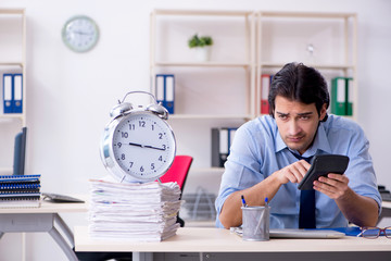 Young male businessman employee unhappy with excessive work  