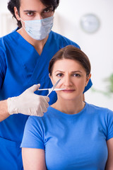 Woman visiting male doctor for plastic surgery  