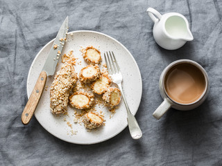 Healthy protein snack, breakfast - peanut butter, seeds, banana nut bites on a grey background, top view