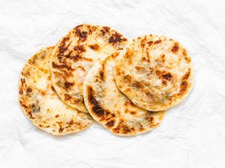 Indian paratha flatbread on a light background, top view