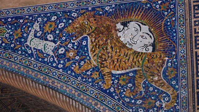 Steady, close up shot of a tiger and other designs on the Sher-Dor Madrasah Iwan.