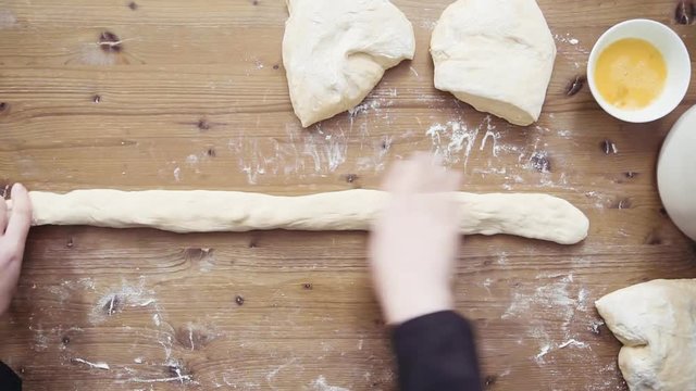 Time lapse. Flat lay. Step by step. Rolling dough into even parts to bake challah bread.