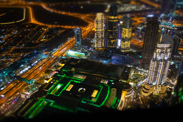 Obraz premium Aerial view of the illuminated night city. Tilt-shift effect.