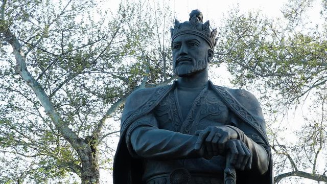 Steady, medium close up shot of a statue of King Amur Timur.