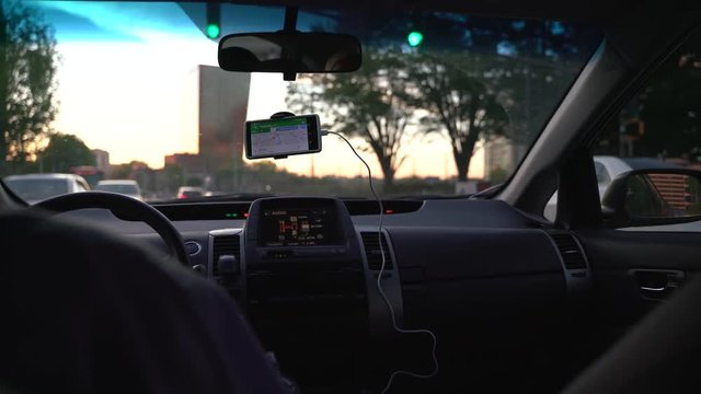 Atlanta, USA - April 5, 2019 : a trip to the city with uber. Situation inside uber car sitting behind the driver.