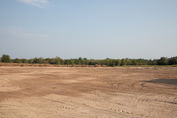 Fototapeta na wymiar empty dirt field on sunny day at Thailand