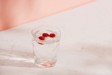 A glass of fresh soda with raspberries