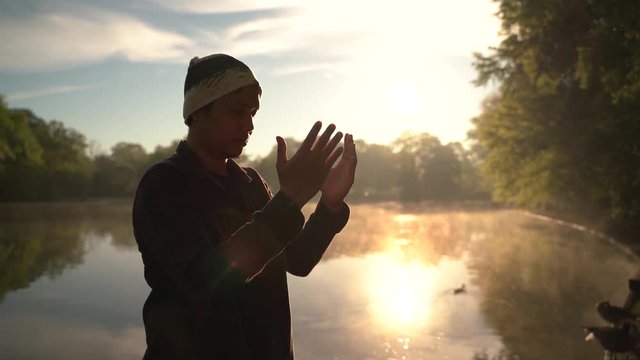 Atlanta, USA - April 1, 2019 : Moslem Man praying outdoor early morning while sunrise. -Video
