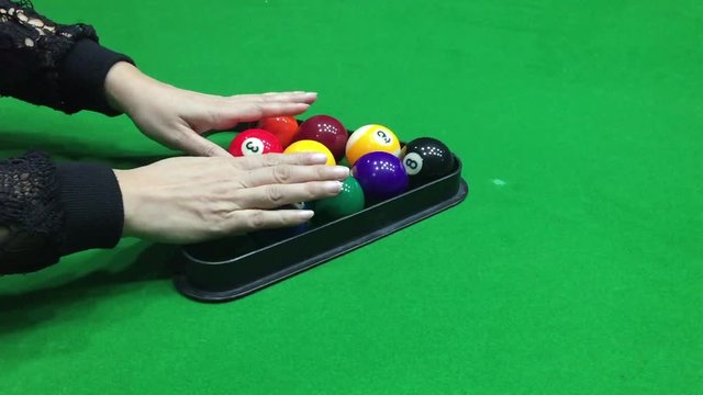 Lady setting up the pool ball for begin the game - people in pool snooker indoor sport concept 