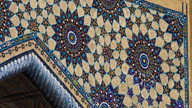 Steady, low angle, medium close up shot of an archway wall of the Ulugh Beg Madrasah.