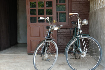 Fototapeta na wymiar vintage bicycle parked in front of brown door of house