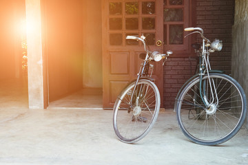 Fototapeta na wymiar vintage bicycle parked in front of brown door of house