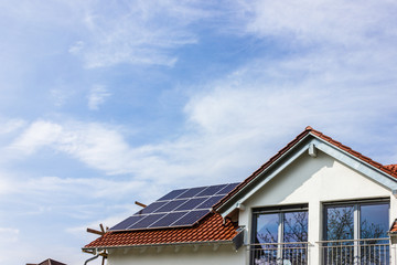 framing house with solar panels on rooftop