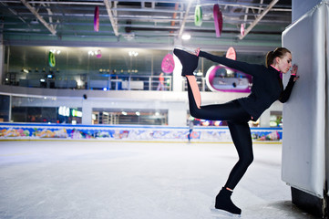 Figure skater woman at ice skating rink.