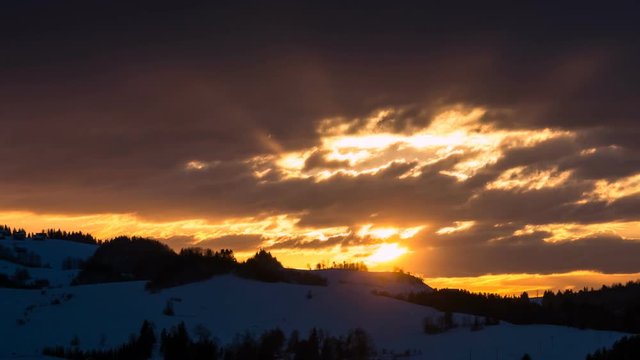Colorful sunrise morning with clouds sky and sunbeam in winter nature landscape Time lapse