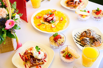 Dessert with croissants, ice cream and sliced fruit