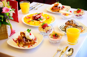Dessert with croissants, ice cream and sliced fruit