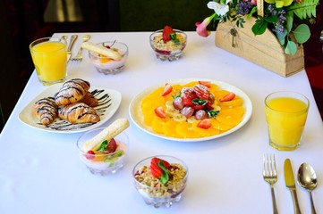Dessert with croissants, ice cream and sliced fruit