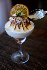 Ice cream with chocolate topping in a glass