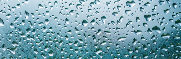 Raindrops are on a windowpane. Concept rainy weather.