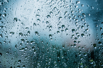 Raindrops are on a windowpane. Concept rainy weather.