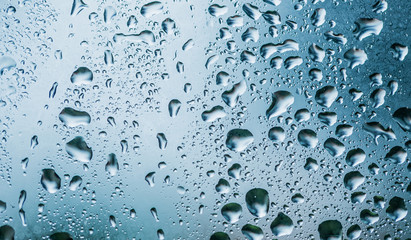 Raindrops are on a windowpane. Concept rainy weather.