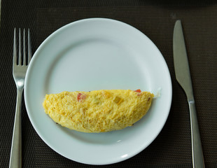 Omelet on white plate ready to serve for breakfast.