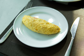 Omelet on white plate ready to serve for breakfast.