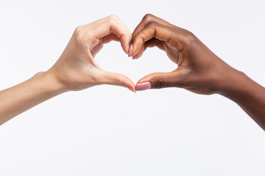 Women with different skin color making heart out of hands