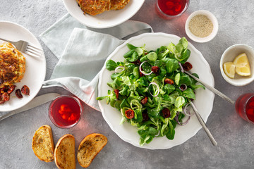 Dinner table with bowl green salad cutlets Rustic style