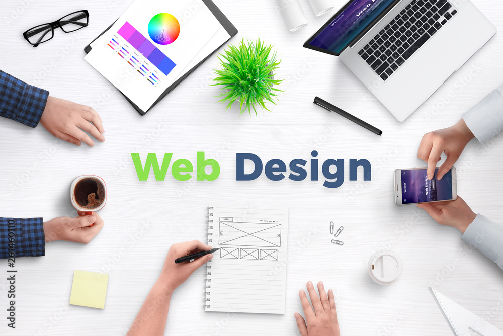 Poster Web design text on work desk surrounded with web development team, devices, projects, and ideas on paper. Concept of team meeting.