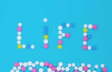 Pills on a blue background in the form of the word life