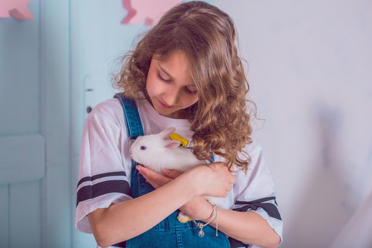 Cute girl with a bunny rabbit has a easter. Beautiful happy child girl with her friend rabbit.  Easter holiday concept 