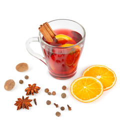 Hot red mulled wine isolated on white background with spices, orange slice, anise and cinnamon sticks.