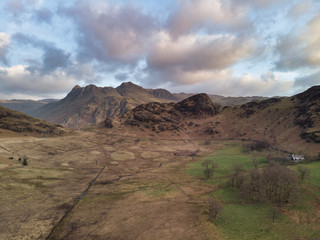 Beautiufl unique drone aerial sunrise landscape image of Blea Tarn and Langdales Range in UK Lake District