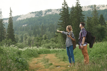 Fototapeta na wymiar Couple navigate with smart phone while hiking